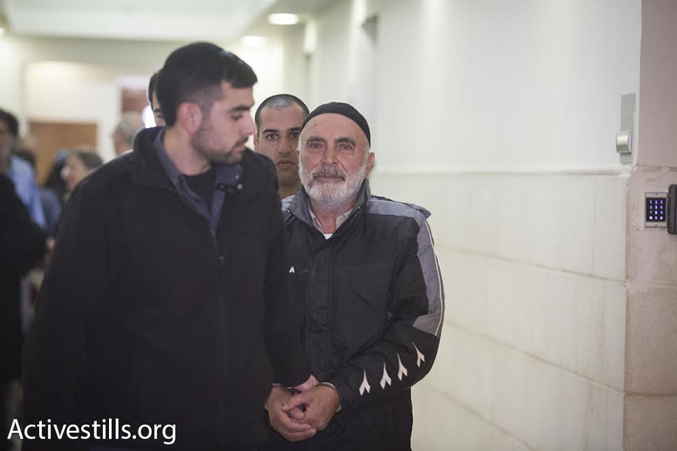 Left-wing activist Ezra Nawi is led into the Jerusalem Magistrate's Court, January 21, 2016. (Oren Ziv/Activestills.org)