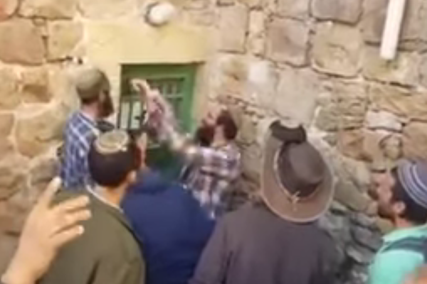 Screenshot of Israelis taking over an empty home in Hebron.