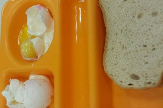 The dinner served in Holot detention center consists of an uncooked hard-boiled egg, tuna, and bread.