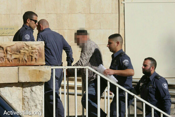 Israeli left-wing activist is led into the Jerusalem Magistrate's Court, January 12, 2015. (Oren Ziv/Activestills.org)