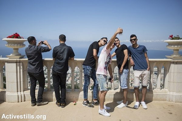 Palestinians, many of whom came from the West Bank, are seen in Haifa during the last day of the Eid al-Fitr, July 19, 2015. (photo: Faiz Abu Rmeleh/Activestills.org)