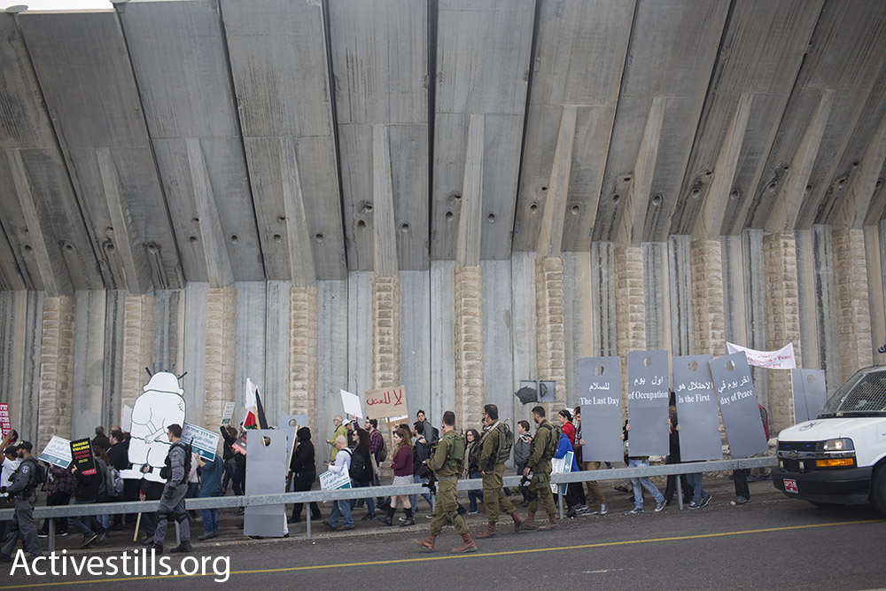 Jewish Israelis and Palestinians march along the major Hebron-Jerusalem highway in the southern West Bank demanding an end to the occupation, Beit Jala, West Bank, January 15, 2016. (Oren Ziv/Activestills.org)
