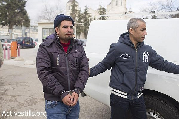 Palestinian anti-occupation activist Nasser Nawajah is accompanied by Israeli attorney Gabi Lasky (right) as he enters the Jerusalem Magistrate's Court, January 20, 2016. (photo: Oren Ziv/Activestills.org)