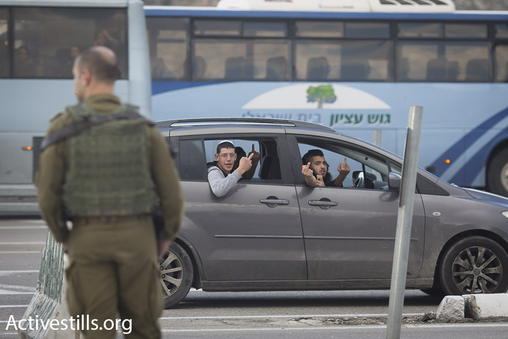Israeli settlers react to the anti-occupation protest along a major West Bank thoroughfare, Beit Jala, West Bank, January 15, 2016. (Oren Ziv/Activestills.org)