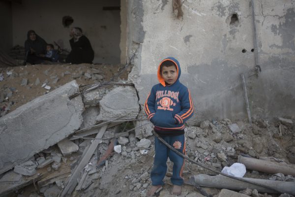 A Palestinian child stands in front of his destroyed home in the Tuffah neighboorhood of Gaza city, Gaza Strip, February 9, 2015. Six months after the Israeli military offensive, tens of thousands of Palestinians are still displaced. (photo: Anne Paq/Activestills.org)