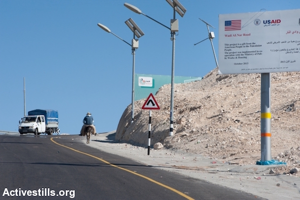 A West Bank road rehabilitated with USAID funding, Wadi Nar, West Bank, February 13, 2014. (Ryan Rodrick Beiler/Activestills.org)