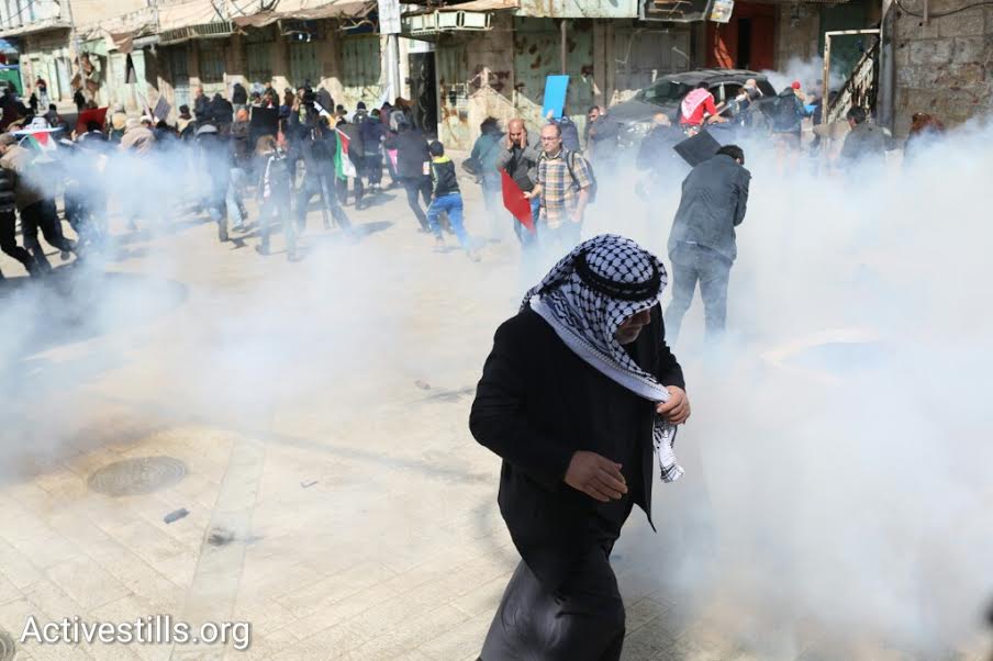 Israeli soldiers shoot tear gas at Palestinian and Israeli protesters in central Hebron, West Bank, February 20, 2016. (photo: Oren Ziv/Activestills.org)