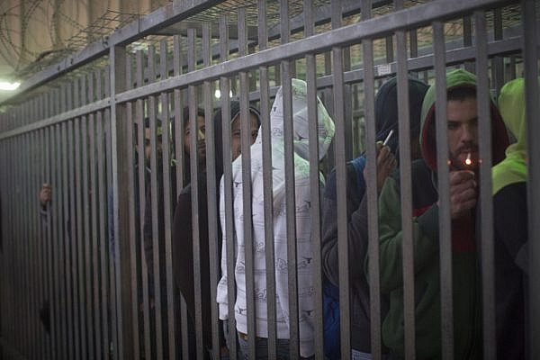 Much of the time spent waiting in Qalandiya checkpoint is spent in narrow, fenced lanes that resemble cattle holds. (Activestills.org)