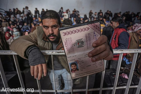 A Palestinian man holds his identification card as he waits at the Rafah crossing, hoping to leave the Gaza Strip into Egypt, February 13, 2016. (Ezz Al Zanoon/Activestills.org)
