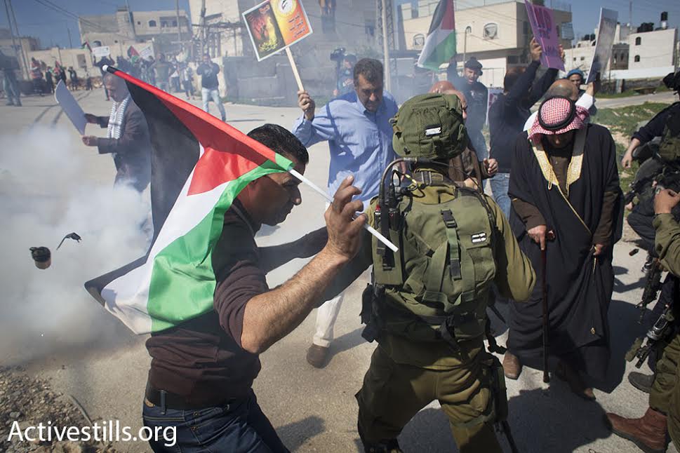 Israeli soldiers fire tear gas and stun grenades at Palestinian activists during a demonstration in Hebron, February 26, 2016. (photo: Oren Ziv/Activestills.org)