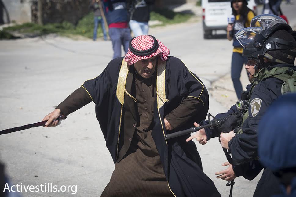 A Palestinian demonstrator confronts Israeli Border Policemen during a demonstration in the West Bank city of Hebron, February 26, 2016. (photo: Oren Ziv/Activestills.org)