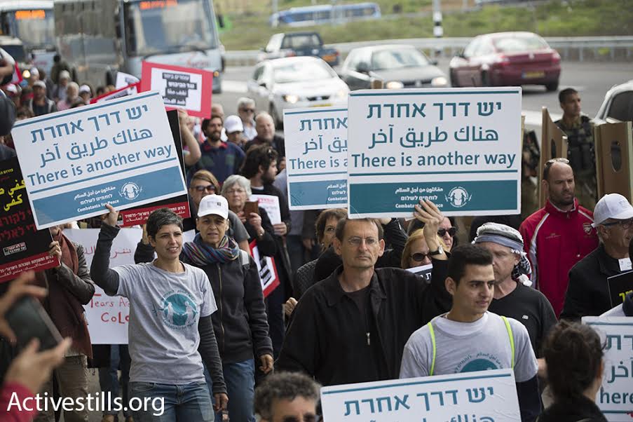 Israeli and Palestinian demonstrators, including Joint List MK Dov Khenin, take part in a march against the occupation, Beit Jala, West Bank, March 4, 2016. (photo: Oren Ziv/Activestills.org)