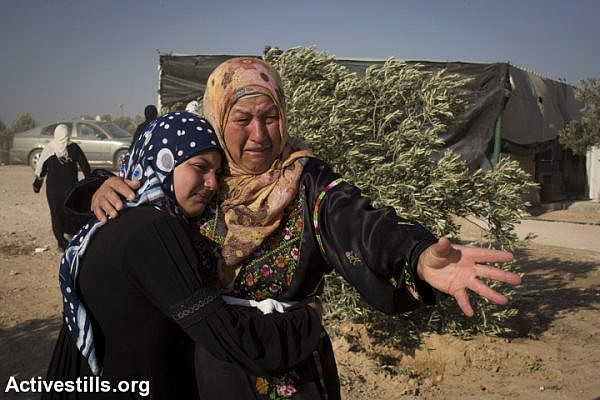 Bedouin women react after Israeli police arrested two boys who were building a shack in the unrecognized Bedouin of Al-Araqib in the Negev desert, one day after the entire village was demolished by the Israeli authorities, June 13, 2014. (photo: Oren Ziv/Activestills.org)
