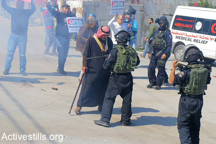 Palestinian activists march during a protest against the closure of Shuhada street to Palestinians, in the West Bank city of Hebron, February 26, 2016. Some 150 protesters gathered to mark the 22th anniversary of the closure of the street by the Israeli army in 1994, following the Hebron mosque massacre by Baruch Goldstein- an Israeli settler who went on a rampage inside Al Ibrahimi Mosque, killing 29 Palestinian worshipers. (Activestills.org)