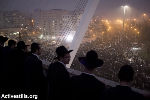 Ultra-Orthodox Jewish men take part in a mass prayer protest against drafting religious Jews into the Israeli army, Jerusalem, March 2, 2014. (Oren Ziv/Activestills.org)