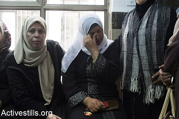 (Suha (C), the mother of Palestinian teenager Mohammed Abu Khdeir, who was murdered last year, sits in the district court in Jerusalem on November 30, 2015. The Jerusalem court convicted two Israeli minors of the kidnapping and burning alive of a Palestinian teenager in the run-up to the 2014 Gaza war, while the third defendant Yosef Haim Ben-David's mental state will be evaluated. Mohammed Abu Khdeir, 16, was abducted and killed on July 2, 2014, weeks after the kidnapping and murder of three Israeli teenagers in the West Bank. Activestills.org)