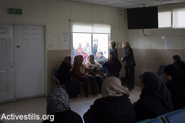 Palestinians women wait for a court hearing of their family members in the Ofer military court, near the West Bank town of Baituniya, February 8, 2015.  (Activestills.org)