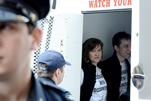 IfNotNow activists seen in a police van following an anti-occupation demonstration inside the Anti-Defamation League's offices. (photo: Gili Getz)