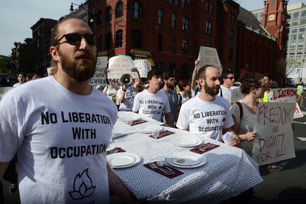 IfNotNow protestors carry a Passover table to the headquarters of Hillel International, where they held a 'Liberation Seder.' (photo: Gili Getz)