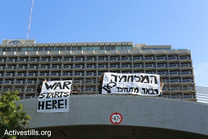 Anti-war activists protest against the The International Air Conference, outside the Tel Aviv Hilton, April 3, 2016. (photo: Oren Ziv/Activestills.org)