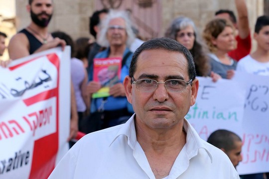 Tawfik Tatour, father of Palestinian poet Dareen Tatour, who was arrested and put under house arrest, demonstrates for her release at Jaffa's Clock Tower Square, June 26, 2016. (photo: Haim Schwarczenberg)