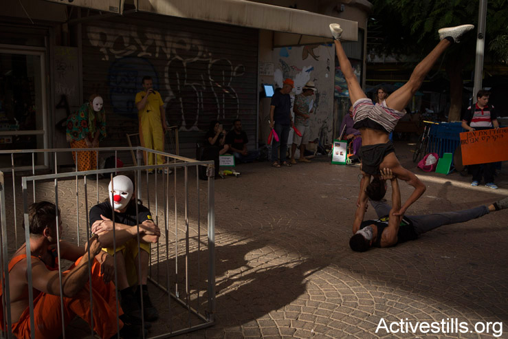 Israeli and Palestinian circus artists protest in Tel Aviv for the release of Palestinian clown, Mohammed Abu Sakha, who is being imprisoned by Israel, July 5, 2016. (Oren Ziv/Activestills.org)