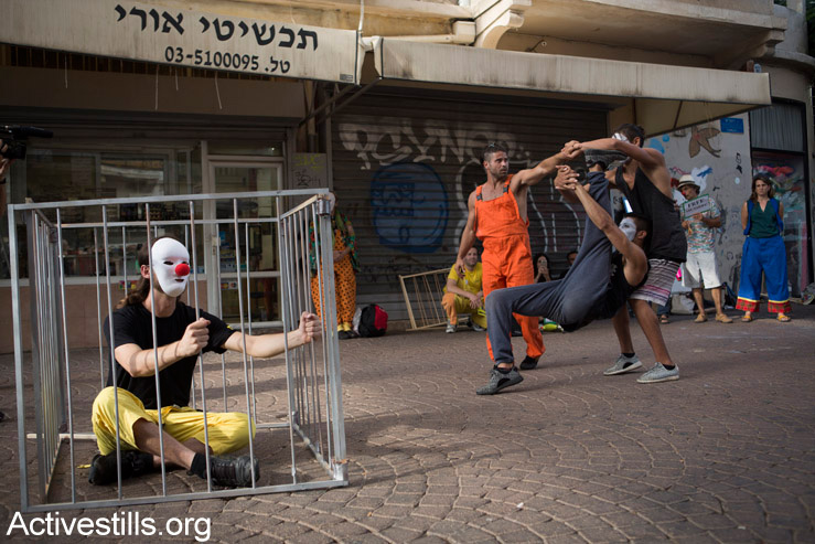 Israeli and Palestinian circus artists protest in Tel Aviv for the release of Palestinian clown, Mohammed Abu Sakha, who is being imprisoned by Israel, July 5, 2016. (Oren Ziv/Activestills.org)