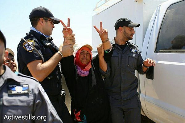 Israeli police detain a Bedouin woman during a march in the unrecognized Bedouin village of Al-Araqib, Negev Desert, July 24, 2016. (photo: Oren Ziv/Activestills.org)