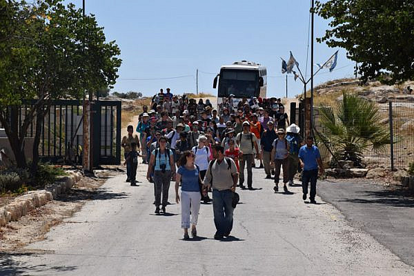 Activists with the Center for Jewish Non-Violence accompany Palestinian residents of Susya into the archeological site where the latter’s village once stood, South Hebron Hills, July 14, 2016. (Michael Schaeffer Omer-Man)