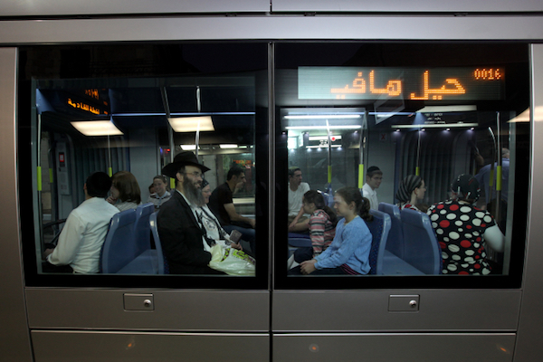 Jewish passengers on the light rail in Jerusalem. (Kobi Gideon/Flash90)