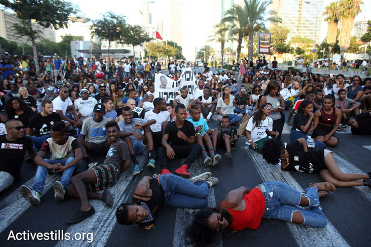 Protesters hold a sit-in during a protest against police brutality targeting Israelis of Ethiopian descent, July 3, 2016. (Oren Ziv/Activestills.org)