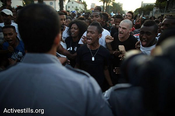 Demonstrators confront police during a protest against police brutality targeting Israelis of Ethiopian descent, July 3, 2016. (Oren Ziv/Activestills.org)