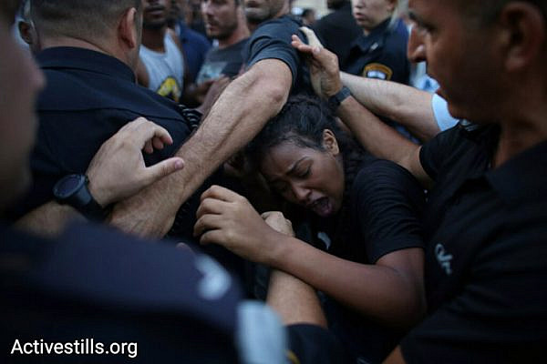 Police push demonstrators back during a protest against police brutality targeting Israelis of Ethiopian descent, July 3, 2016. (Oren Ziv/Activestills.org)