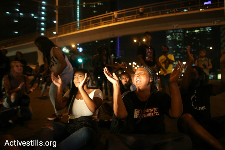 Protesters hold a sit-in during a protest against police brutality targeting Israelis of Ethiopian descent, July 3, 2016. (Oren Ziv/Activestills.org)