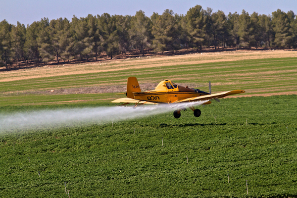 Illustrative photo of a crop-duster spraying agricultural lands with chemical agents. (Doron Horowitz/Flash90)