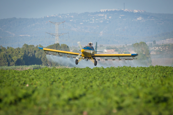 Illustrative photo of a crop-duster spraying agricultural lands with chemical agents. (Moshe Shai/FLASH90)