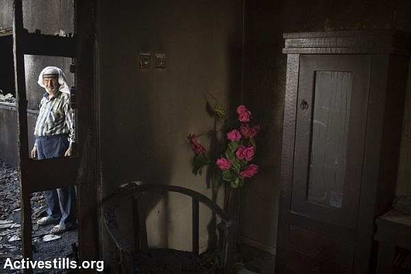 The Dawabshe grandfather stands in the charred home in which his family members were murdered by extremist Jewish settlers, Duma, West Bank, July 31, 2015. (Oren Ziv/Activestills.org)