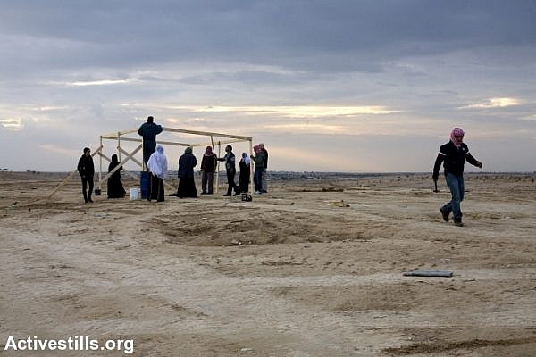 Residents of al-Araqib rebuild a structure demolished by Israeli authorities, January 16, 2011.
(Keren Manor/Activestills.org)