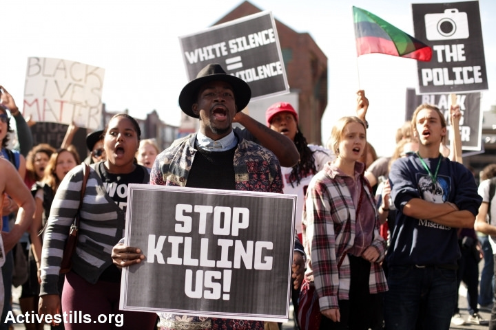 Activists march down the upscale shopping area on Newbury st, in Boston MA, on Saturday, October 25th, 2014 calling for an end to police racial profiling and violence. The protest came in the wake of events in Ferguson, MO, following the fatal shooting by police of an unarmed black man. (Activestills.org)