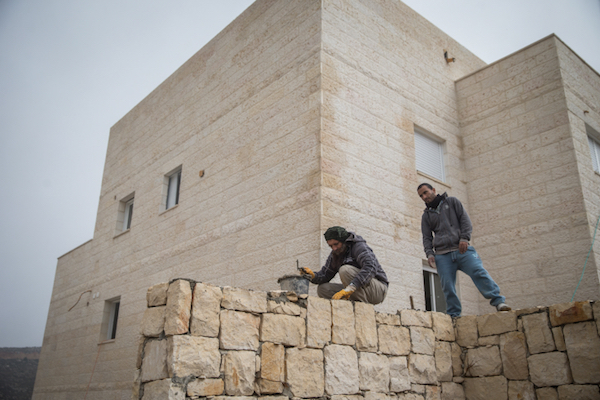 Palestinian construction workers in an Israeli settlement in the West Bank, November 10, 2015. (Nati Shohat/Flash90)