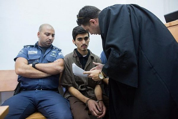 Fares Sritah, 19, from the Jerusalem neighborhood Beit Hanina neighborhood, is brought to Jerusalem's District Court, August 13, 2015. Sritah was charged with attempting to join Islamic State. (Yonatan Sindel/Flash90)