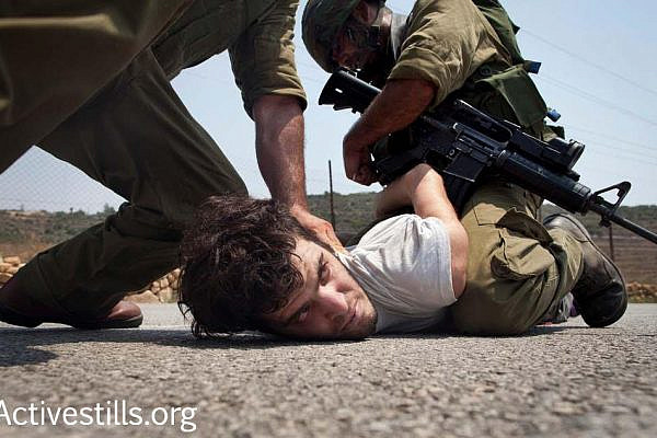Israeli activist Renen Raz is seen arrested by Israeli soldiers during a demonstration in the West Bank village Nabi Saleh. Raz passed away in October 2016. (Activestills.org)