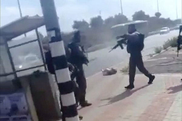 Screenshot of a video showing Israel Border Police officers shooting a 19-year-old Palestinian attacker after she is on the ground.