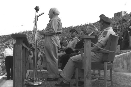 Defense Minister David Ben-Gurion, with Moshe Dayan, at an Independence Day celebration in 1955. (Moshe Pridan/GPO)