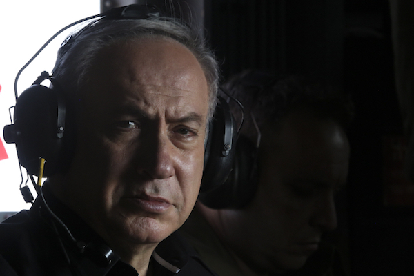 Israeli Prime Minister Benjamin Netanyahu in a helicopter as he tours the separation fence near the Palestinian town of Tarqumiyah, West Bank, July 20, 2016. (Marc Israel Sellem/Pool)