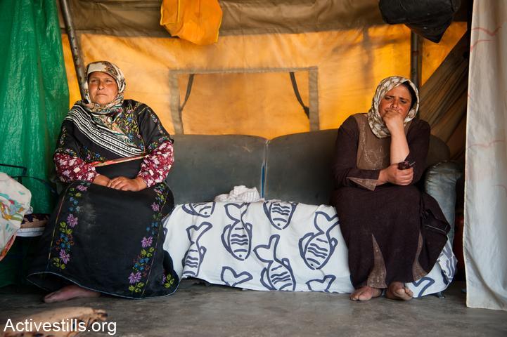 Women from the village of Khirbet al Tabban sit in their tent home, south Hebron Hills, West Bank, October 17, 2012. The village is one of eight slated for demolition in the area of the South Hebron Hills, designated by the Israeli military as "Firing Zone 918." (Ryan Rodrick Beiler/Activestills.org)