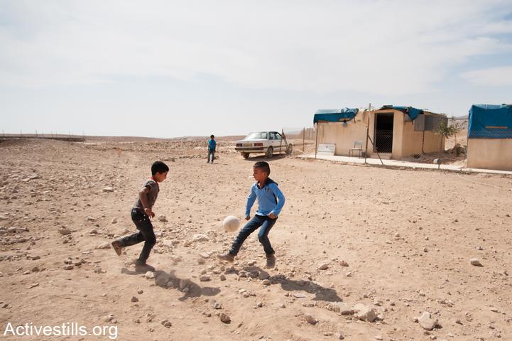 Students play soccer outside of their school in the village of Khirbet al Fakheit, South Hebron Hills, West Bank, October 17, 2012. The school faces a demolition order by Israeli authorities, and teachers who come from nearby Yatta have been harassed by the Israeli military and told they are prohibited from driving their cars in the area. This village of nine families is one of the eight Palestinian communities slated for demolition in the area of the South Hebron Hills designated by the Israeli military as "Firing Zone 918." (Ryan Rodrick Beiler/Activestills.org)