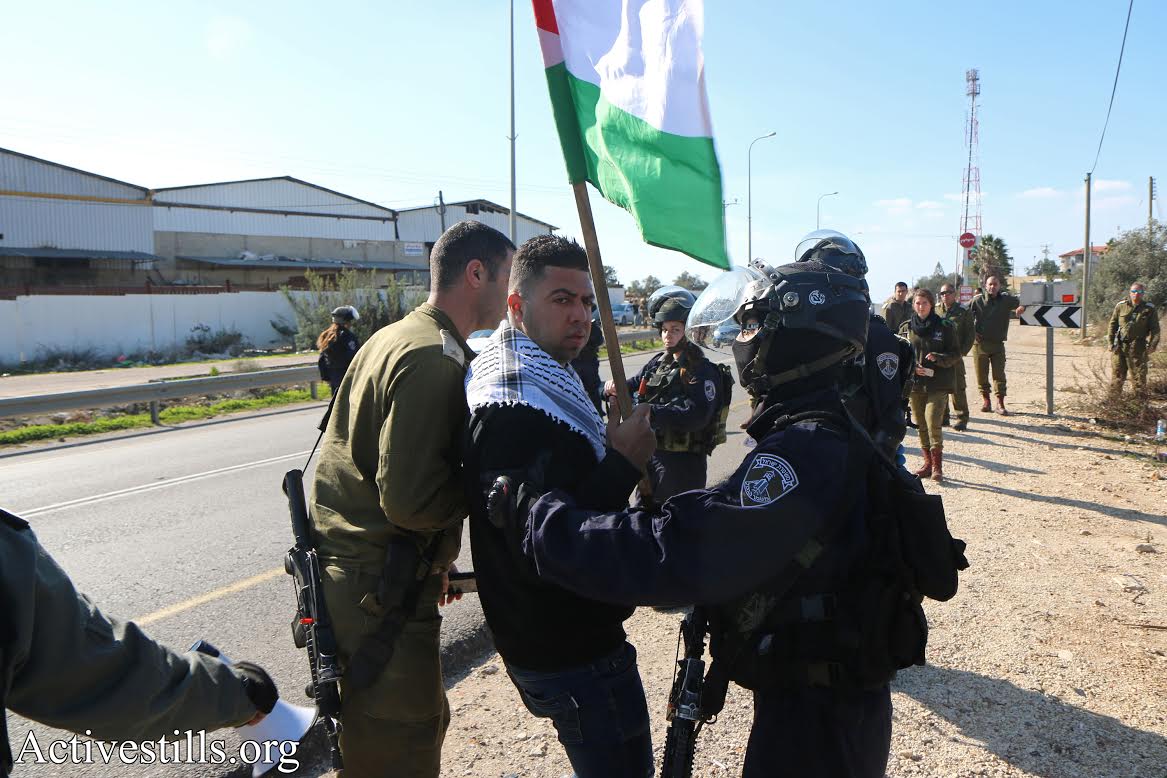 Israeli security forces detain a Palestinian protester in Nabi Elias, where dozens of Palestinians and several Israelis protested against plans to expropriate agricultural land to build a settler-only bypass road. (Ahmad al-Bazz/Activestills.org)