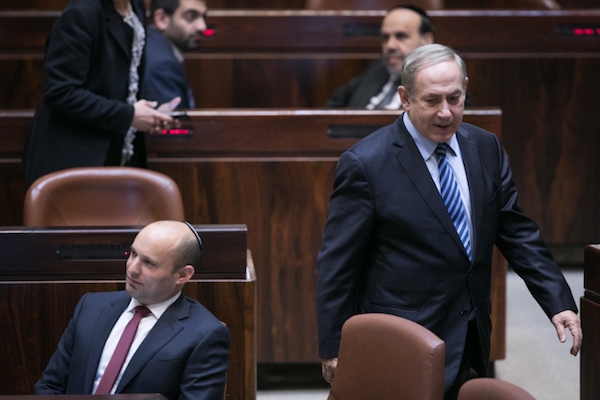 Education Minister Naftali Bennett and Prime Minister Benjamin Netanyahu during the Knesset vote on the outpost ‘normalization law,’ December 5, 2016. (Yonatan Sindel/Flash90)