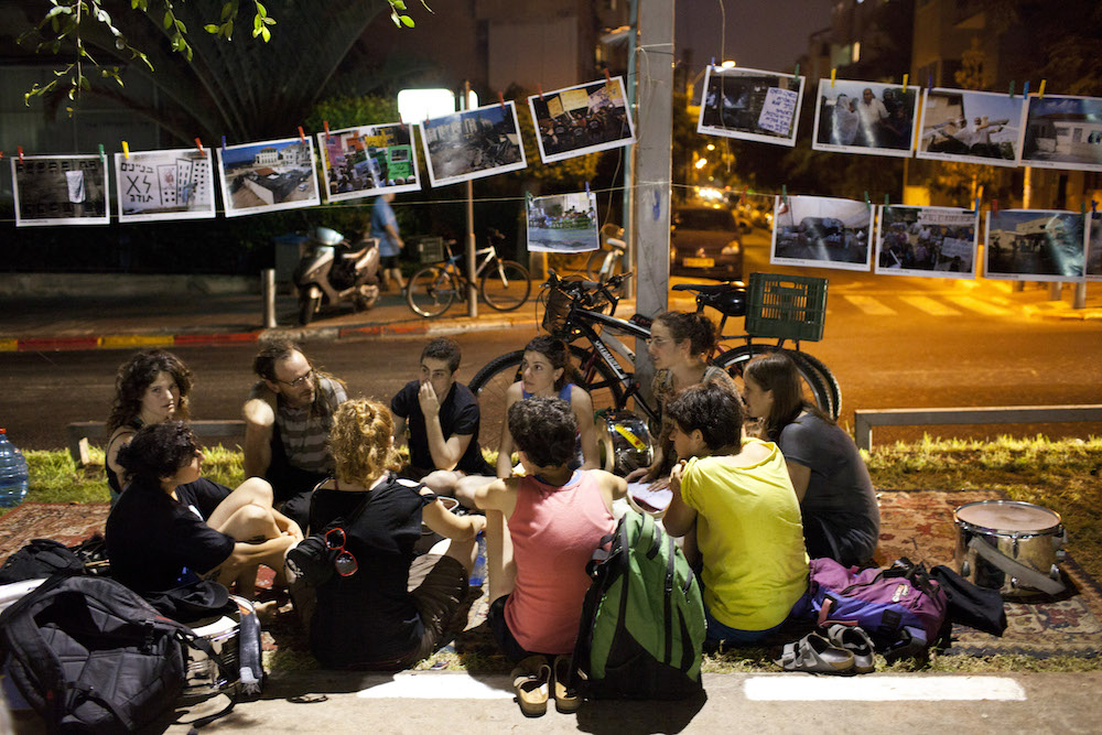 An Activestills photo exhibition at the Rothschild tent encampment during Israel’s 2011 social protests, July 20, 2011. (Activestills.org)